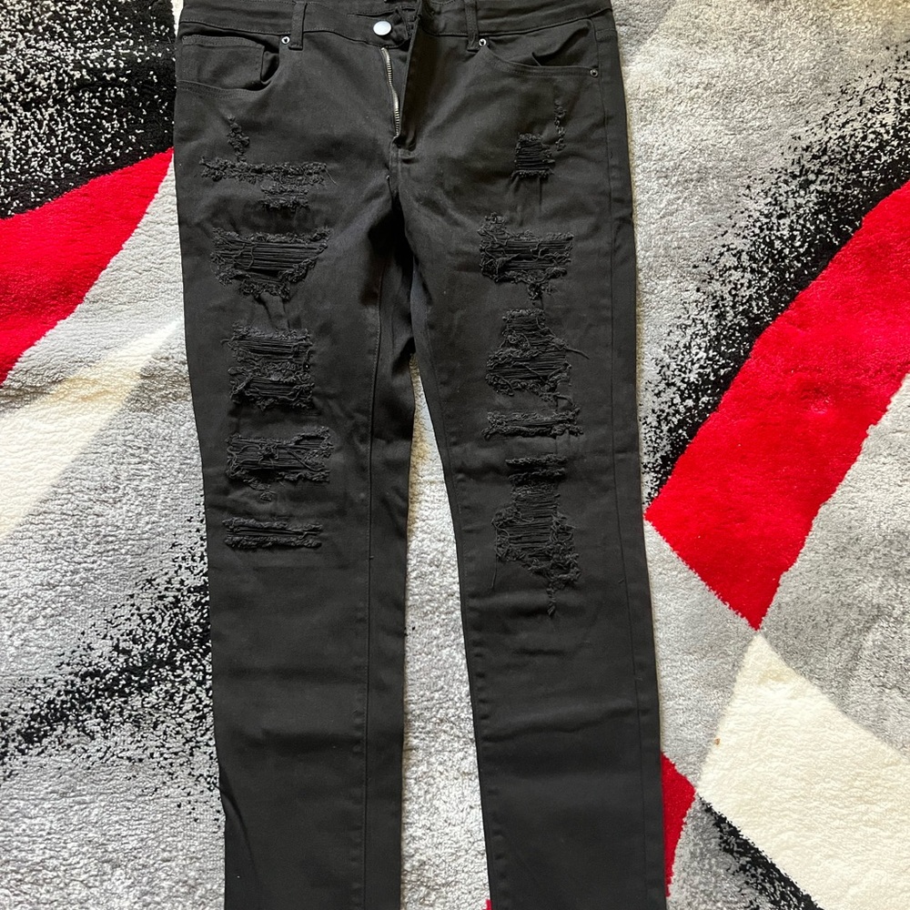 Black fitting ripped skinny jeans.